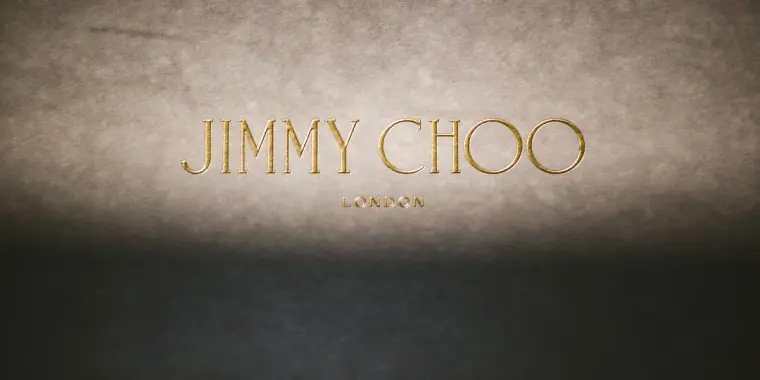 Close-up of a Jimmy Choo shoe box lid with gold lettering