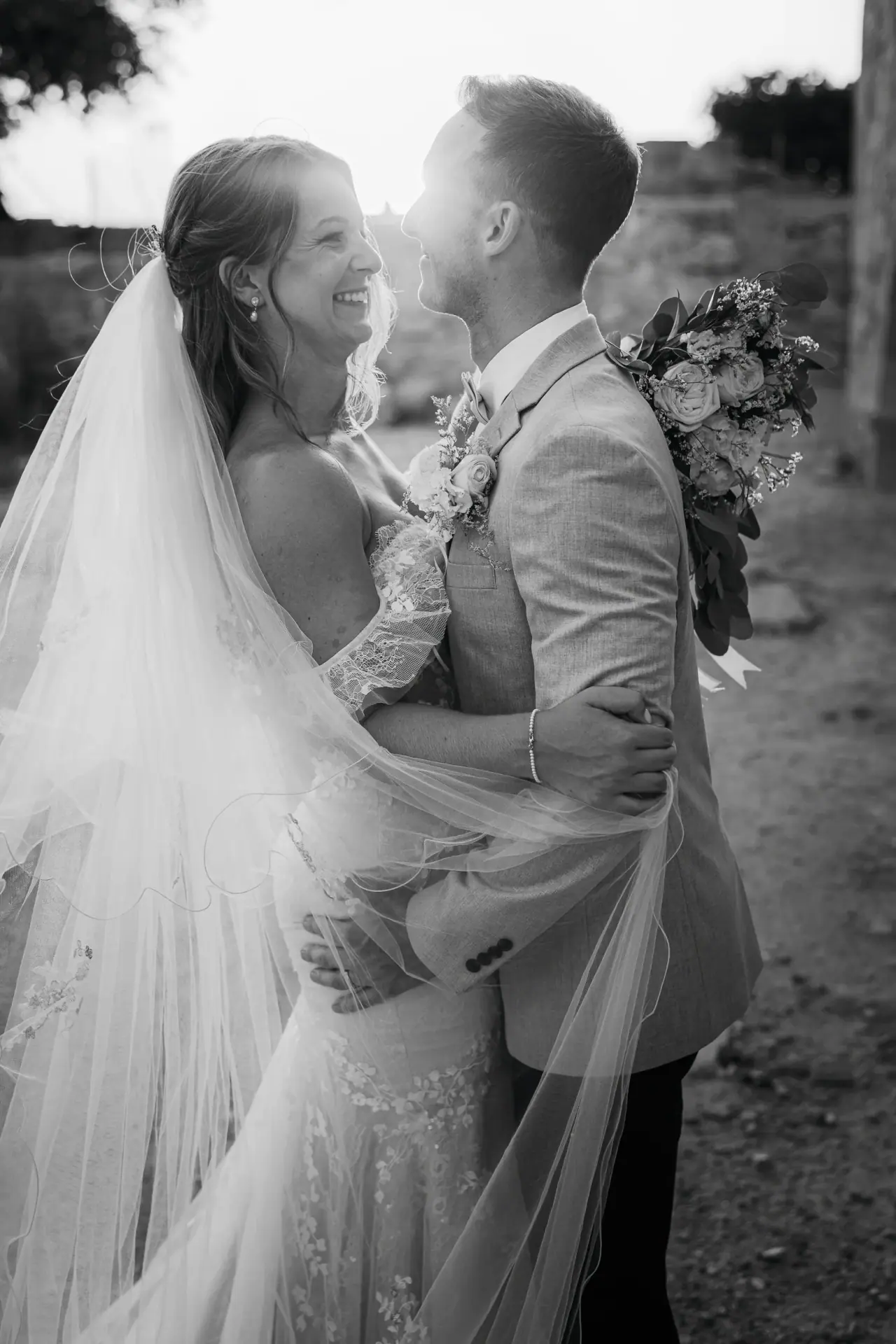 Black-and-white photo of Laura gazing up at Lewis, her veil falling behind her