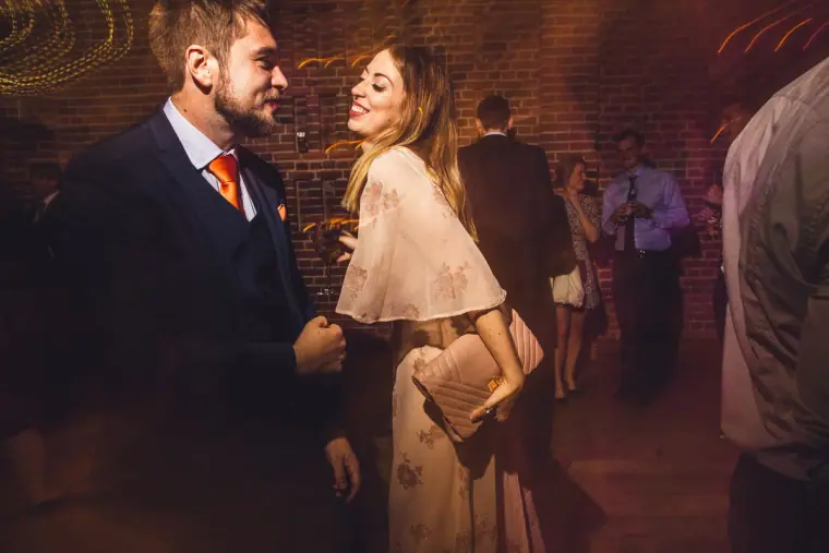 Couple of guests laughing together on the dance floor