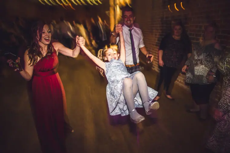 Guest swinging a young girl around on the dance floor