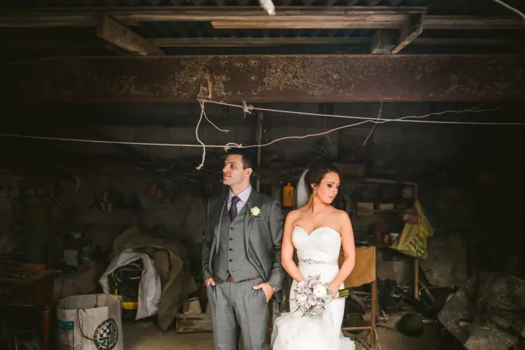 Casey and Joe standing in a rustic workshop with exposed beams, Paphos