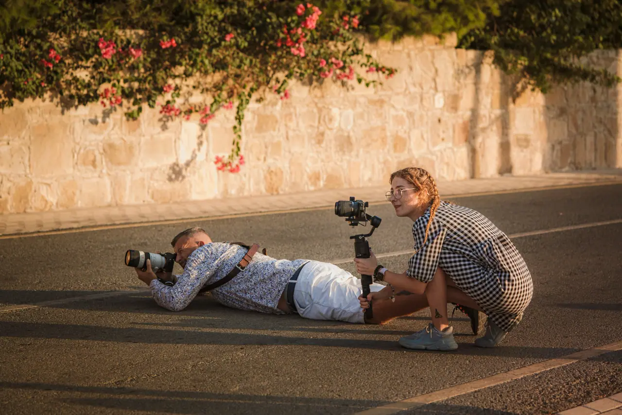 Photographers lying on the road with camera and gimbal, behind the scenes at Liopetro