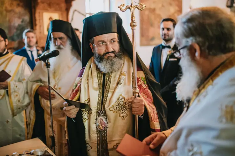 Orthodox bishop and priests in ornate robes officiating at the ceremony, Limassol
