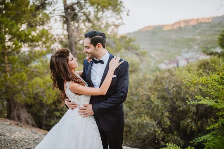 Couple embracing on a wooded hillside with a valley view, Limassol