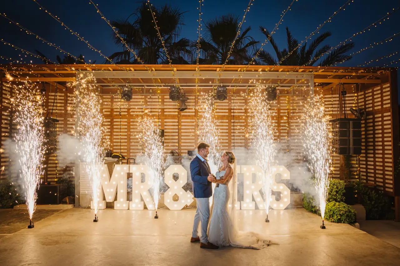 Jodie and Joe's first dance between sparkler fountains and Mr & Mrs letters at Alassos