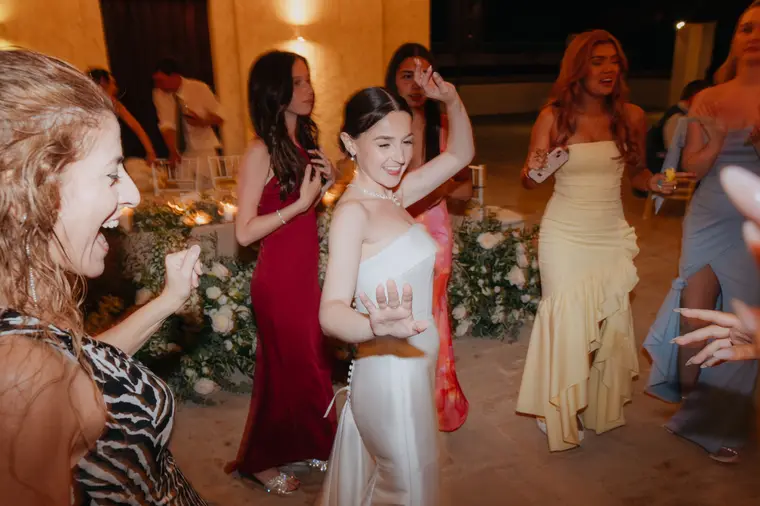 Bride dancing with guests at the evening reception