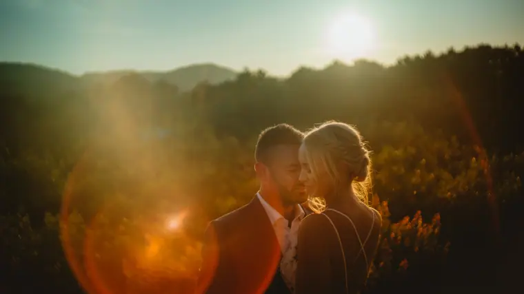 Sophie and Iain close together at sunset with lens flare over the hills, Can Gall, Ibiza
